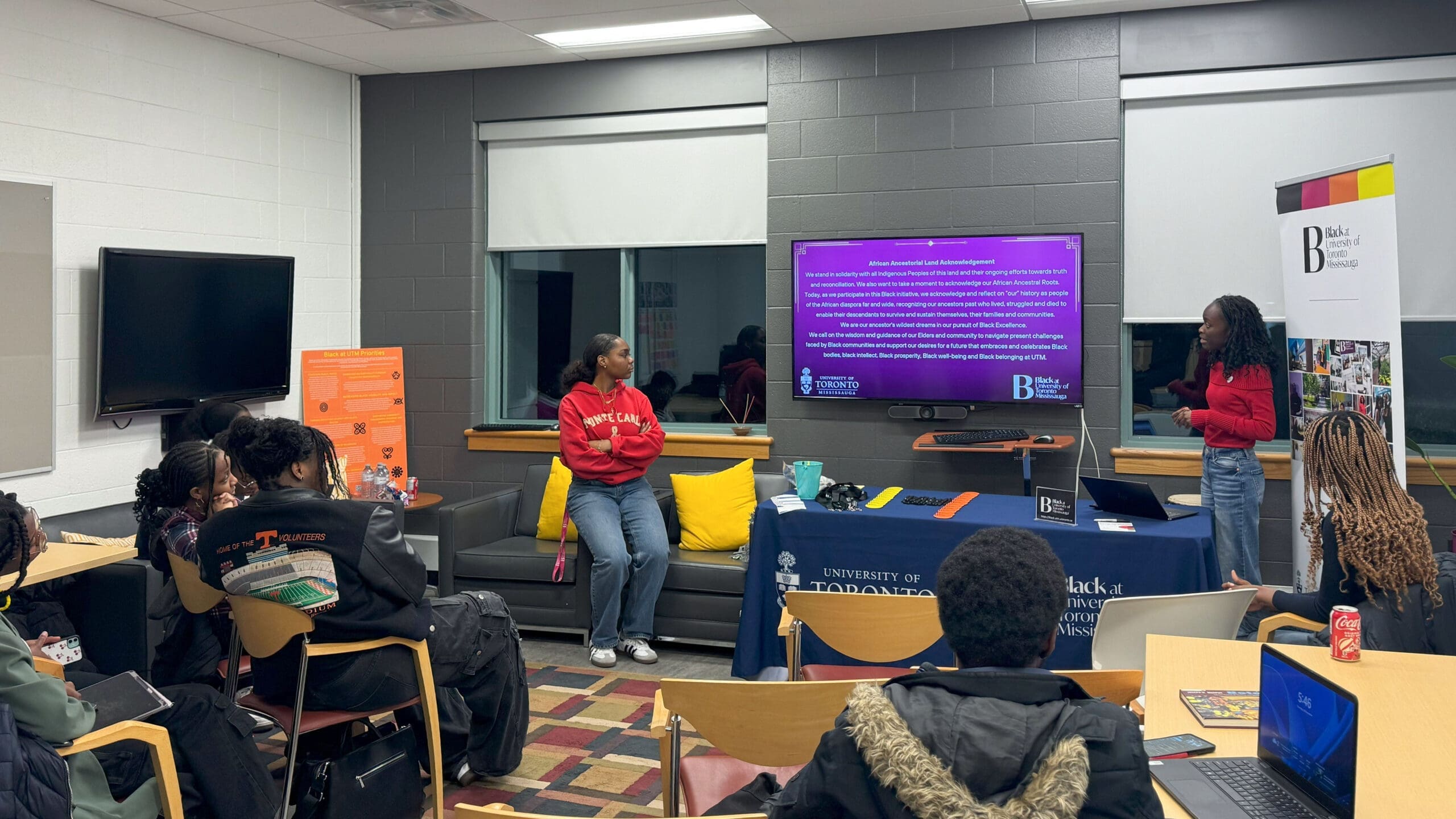 black-at-utm-115 Two students standing before a screen in the CBEB giving a presentation