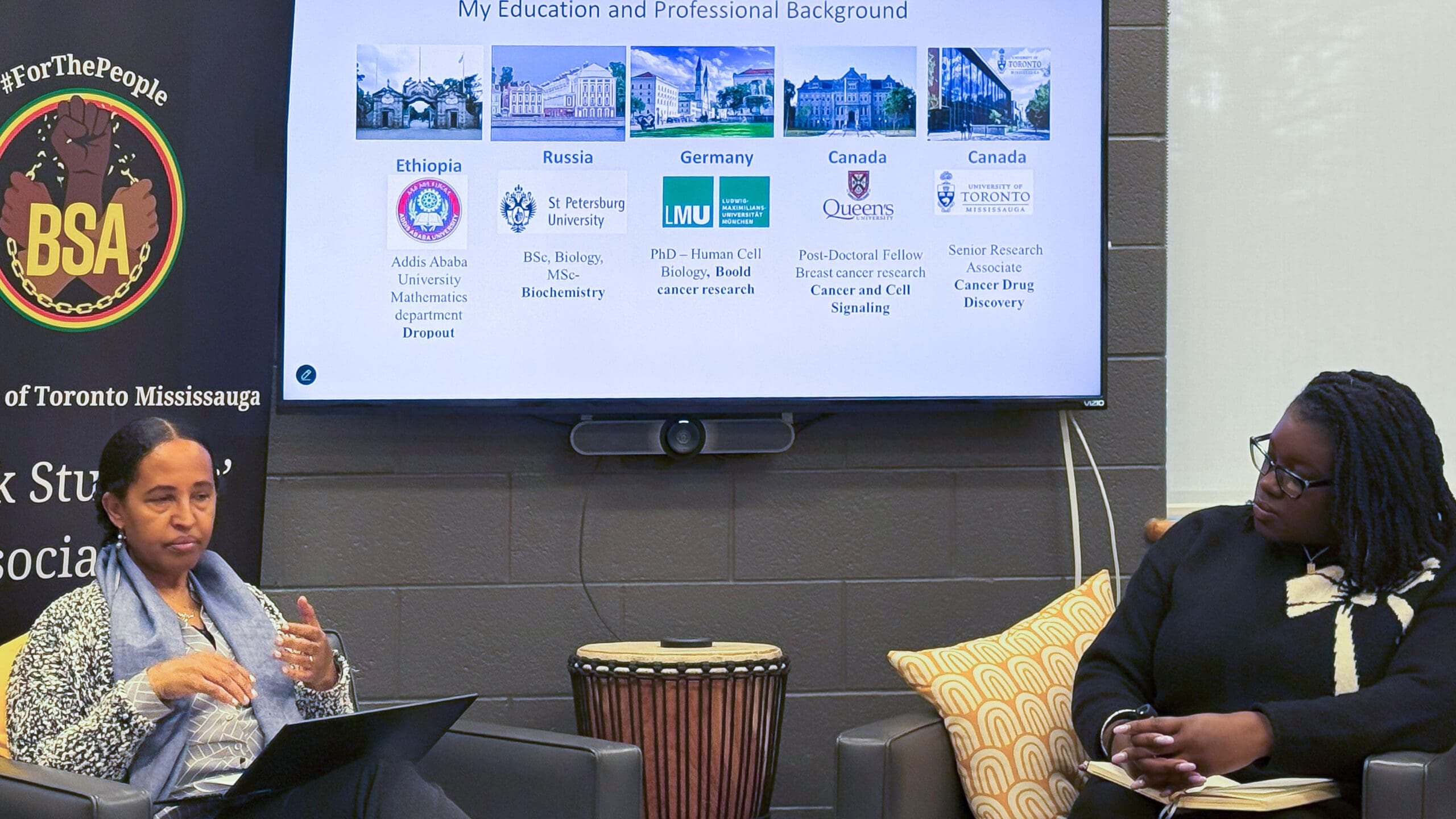 cbeb-image-4 A panel speaker seated in front of a screen with a guest