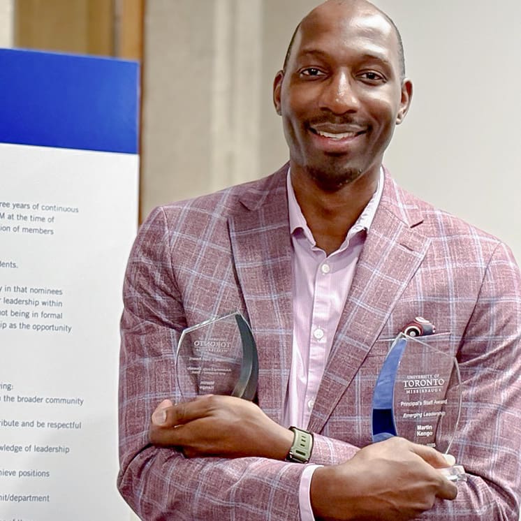 Martin Kengo holding Awards